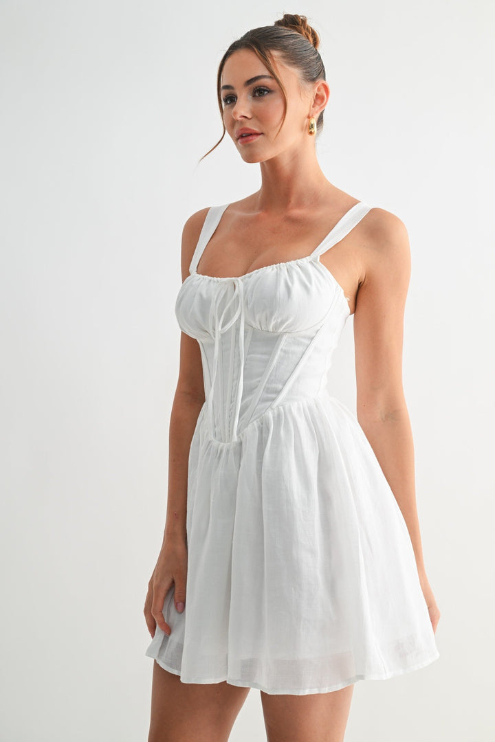 White linen corset mini dress with thick straps, three-quarter view