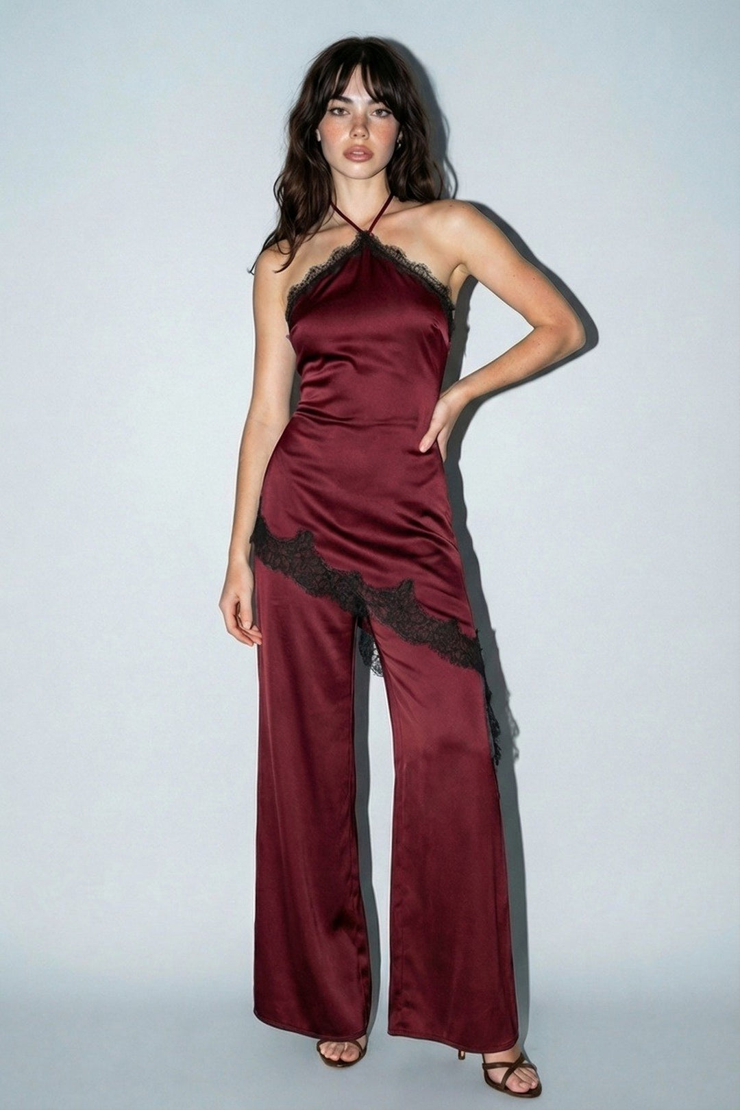 Wine satin halter jumpsuit with contrast lace trim and wide legs, front view