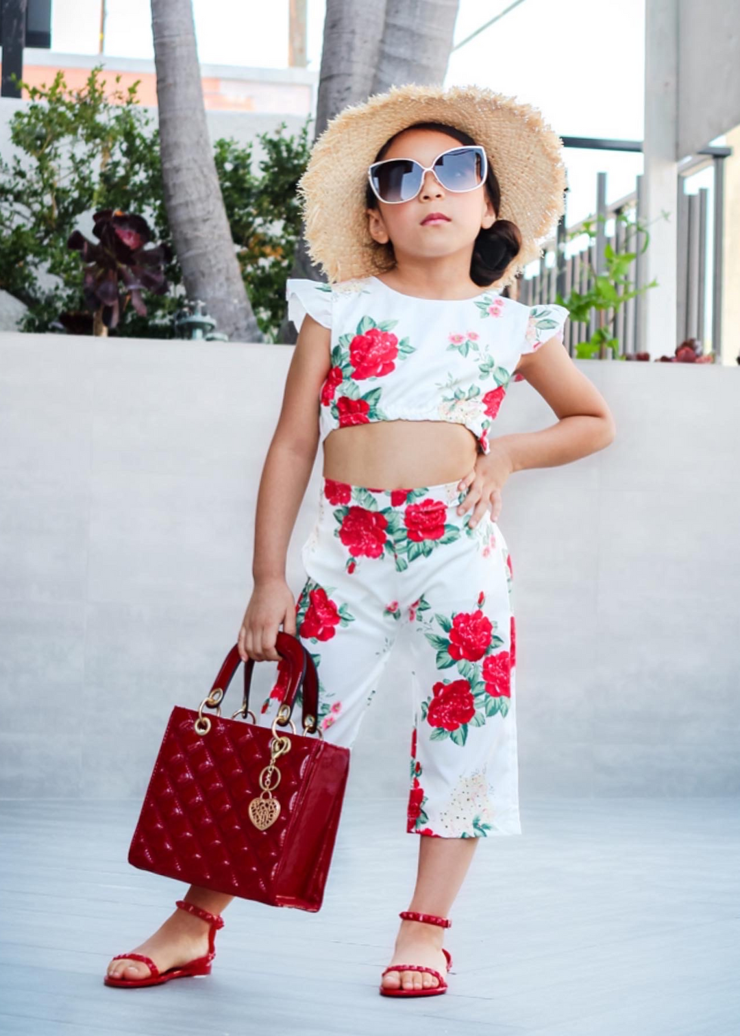 Aria Kids red jelly sandals with thin strap across the toes and thin ankle strap. Shoes for beach and pool days. Wear them all year long with a casual chic look