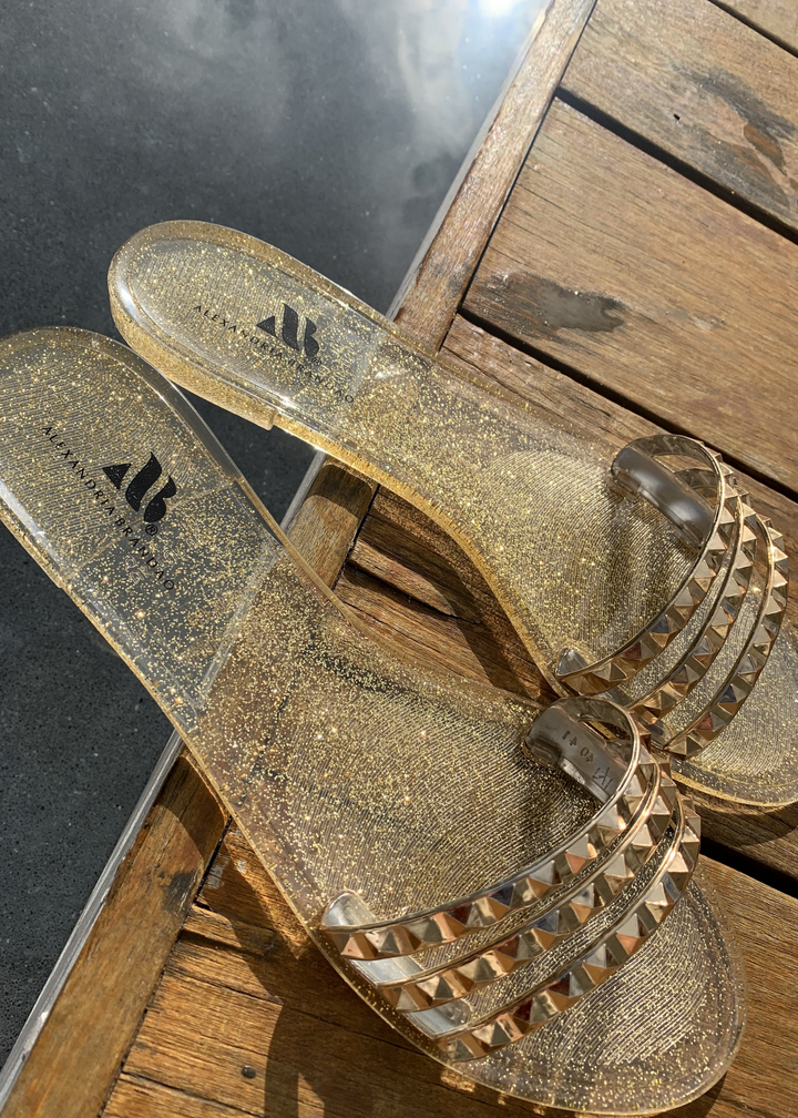 Close up of Aria B gold jelly sandals.