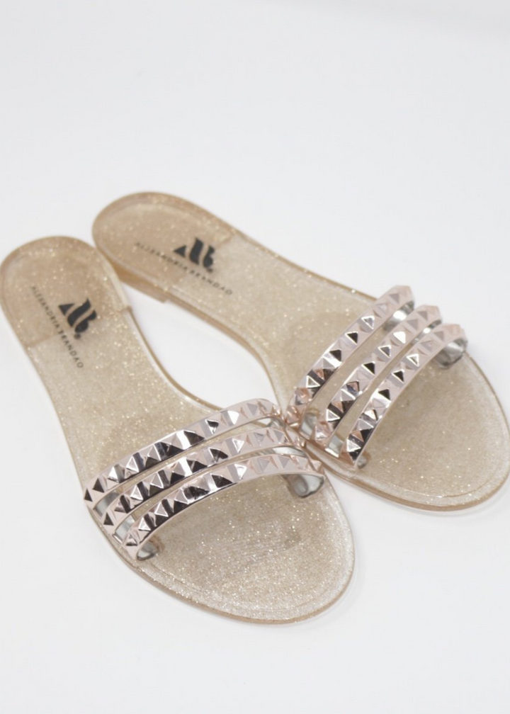 Aria B rose gold jelly slides with three studded straps across  the toes.