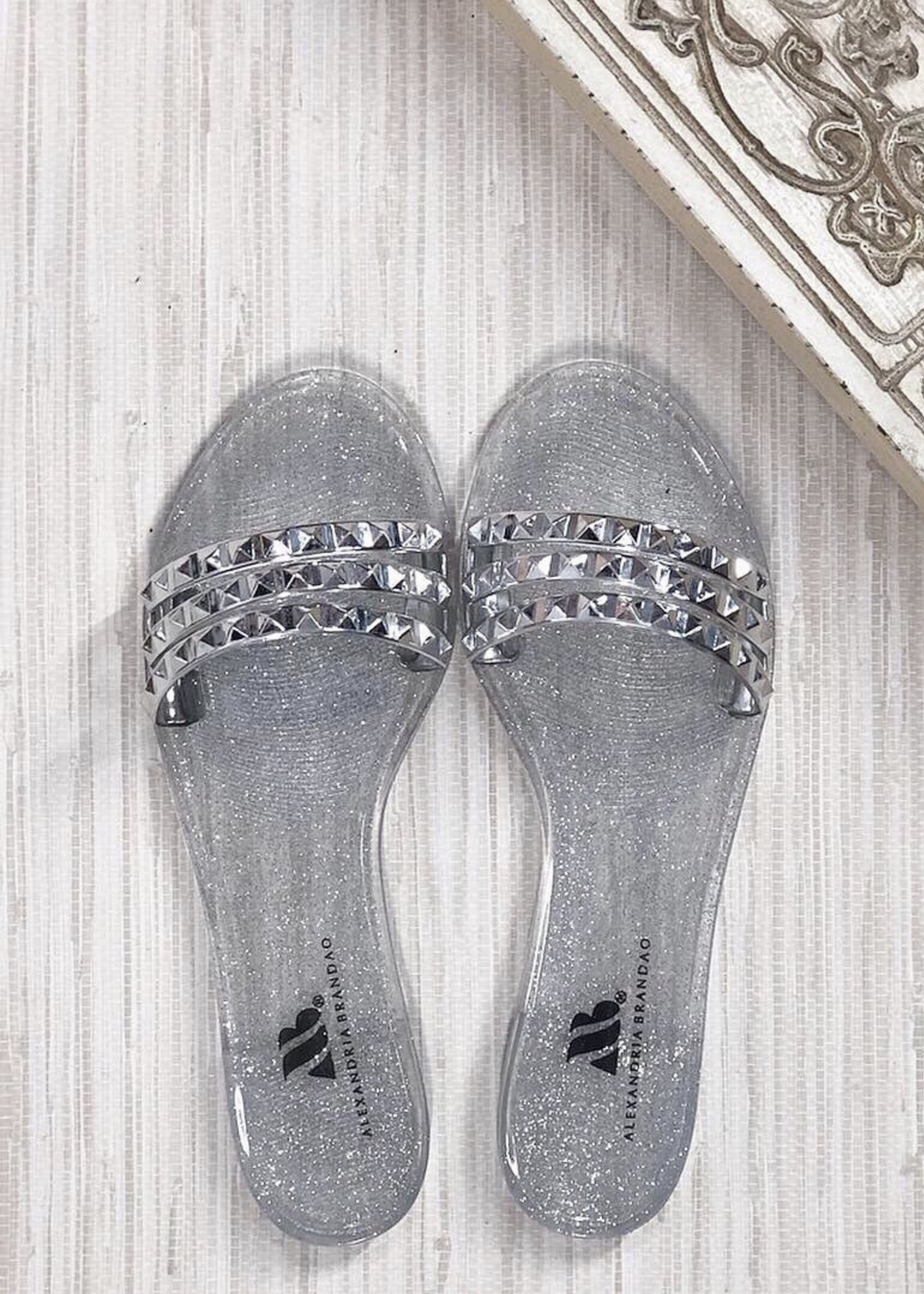 Aria B silver jelly slide sandal with three studded straps across the toes.