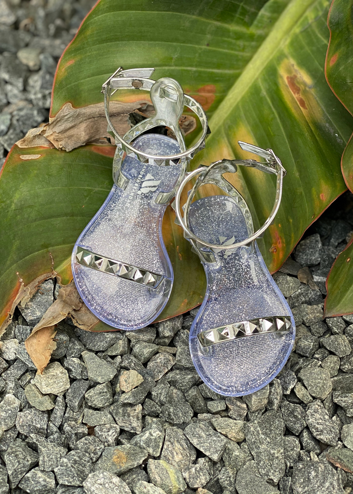 Aria Kids silver jelly sandals with thin strap across the toes and thin ankle strap