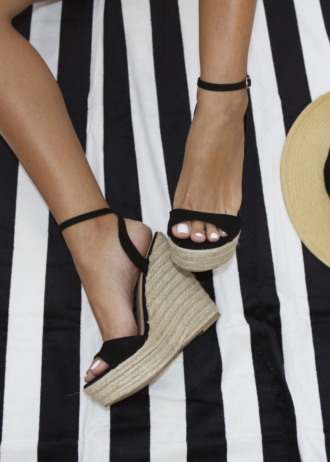 Alyssa B Espadrille Wedge in Black on a black and white beach towel. Alyssa B is a show stopper for any pool party.